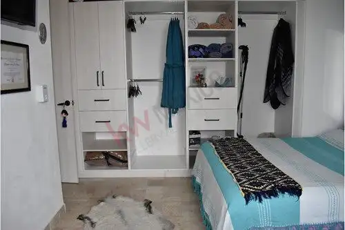 Condo closet with organized shelves, hanging space, and storage in La Luminaria, San Miguel de Allen.