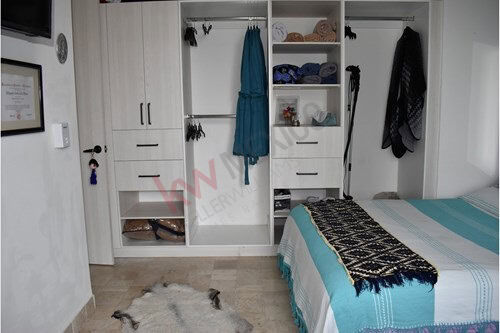 Floor condo closet with organized storage in La Luminaria, San Miguel de Allende.