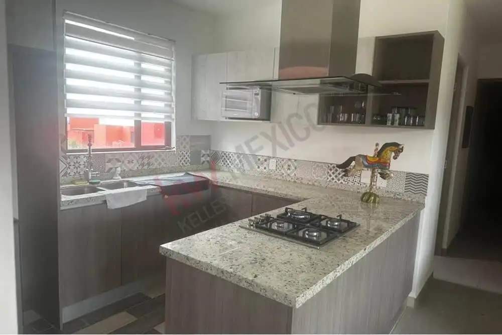 Kitchen with mountain views, granite countertops, and contemporary cabinetry in San Miguel de Allend.