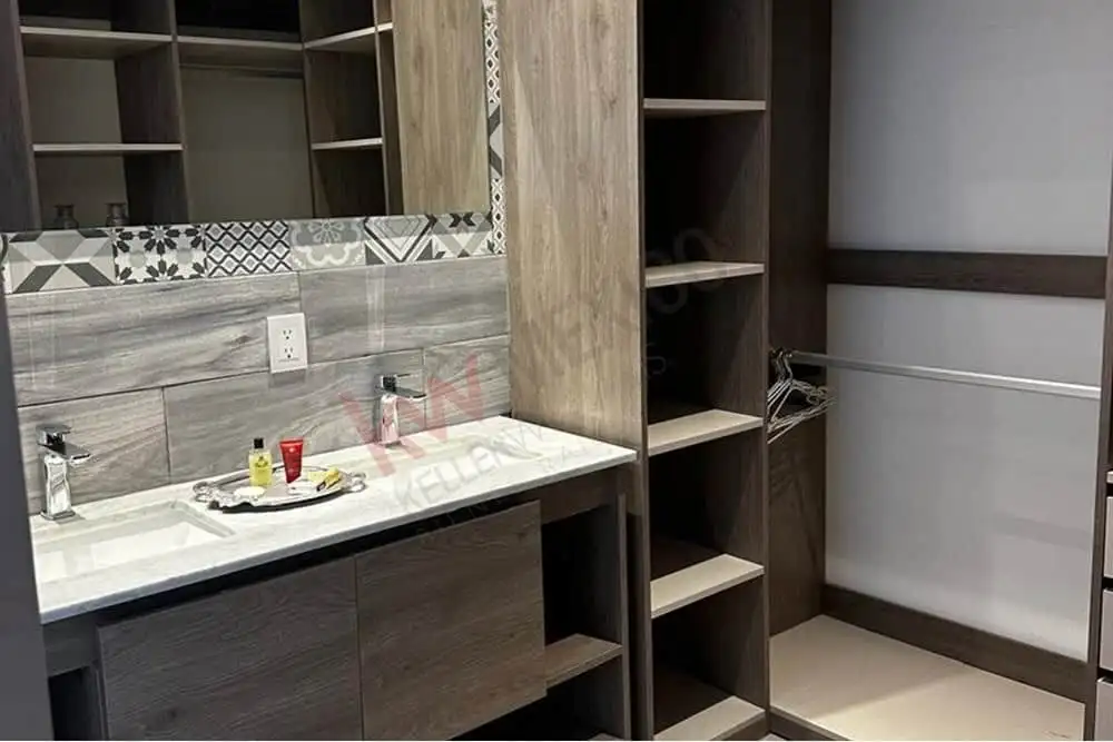 Elegant kitchen with custom wood cabinets and marble countertop in Punta de Cielo.