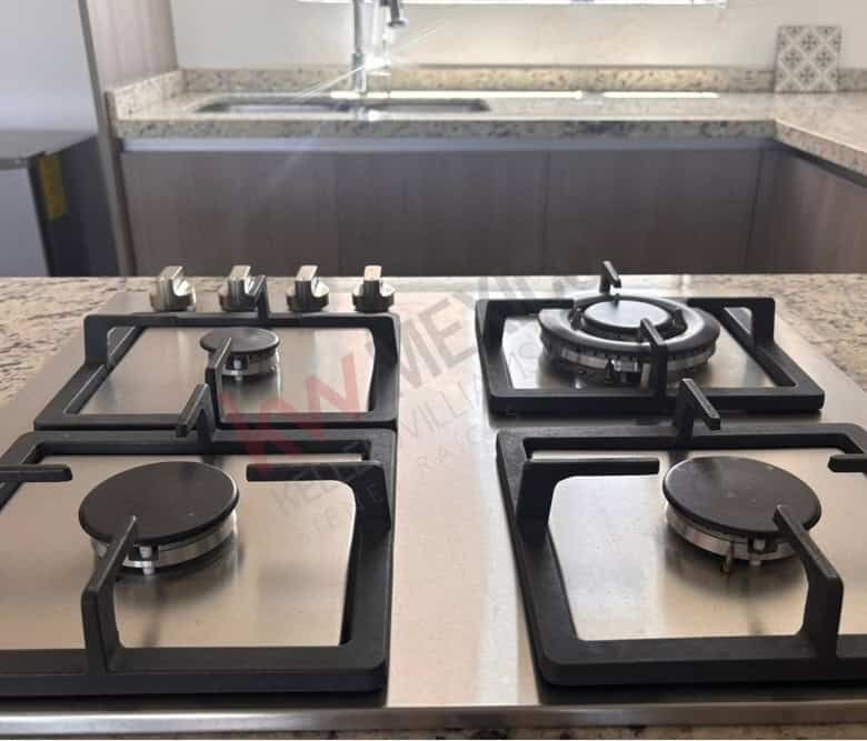 Gas stove with four burners in a modern kitchen for cooking and meal preparation.