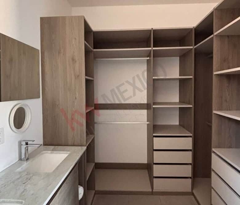 In closet featuring organized shelving and drawers for clothing and accessories.