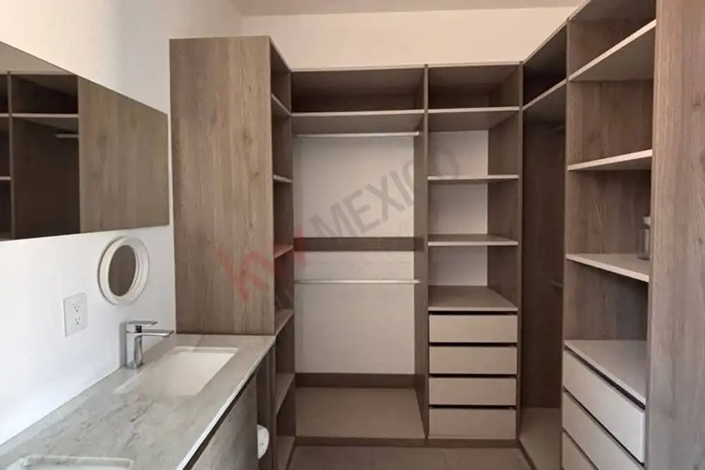 In closet featuring organized shelving and drawers for clothing and accessories.