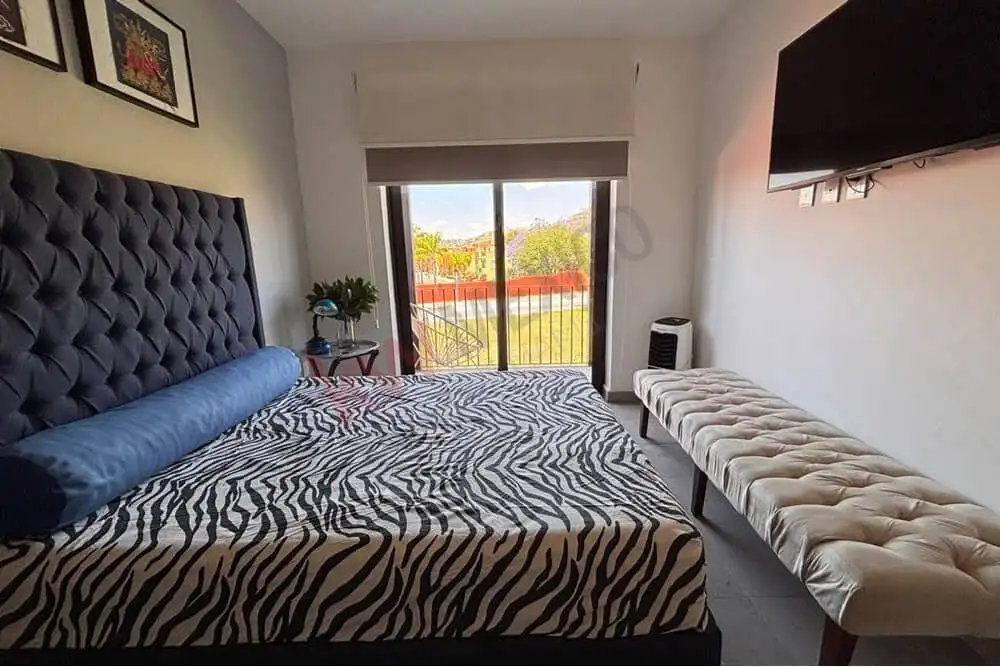 Bright bedroom featuring a large window with scenic Picachos Mountain vistas.