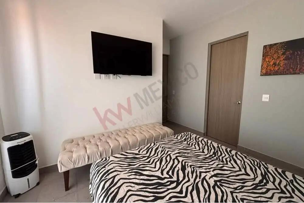 Cozy bedroom featuring a wall-mounted TV, stylish zebra print bedding, and scenic mountain views in.