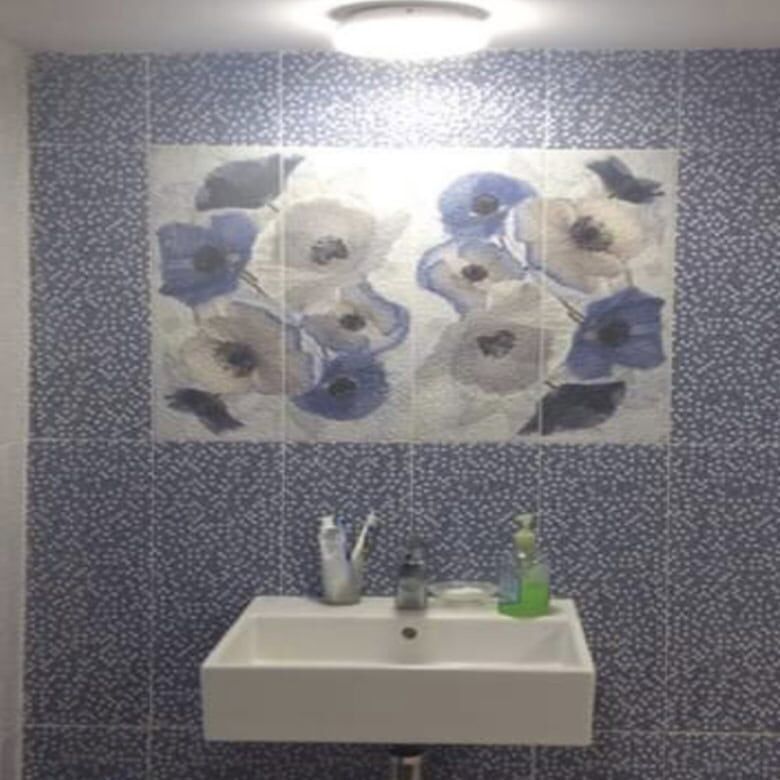 Bright bathroom featuring a blue floral mural, white sink, and natural light from the window.