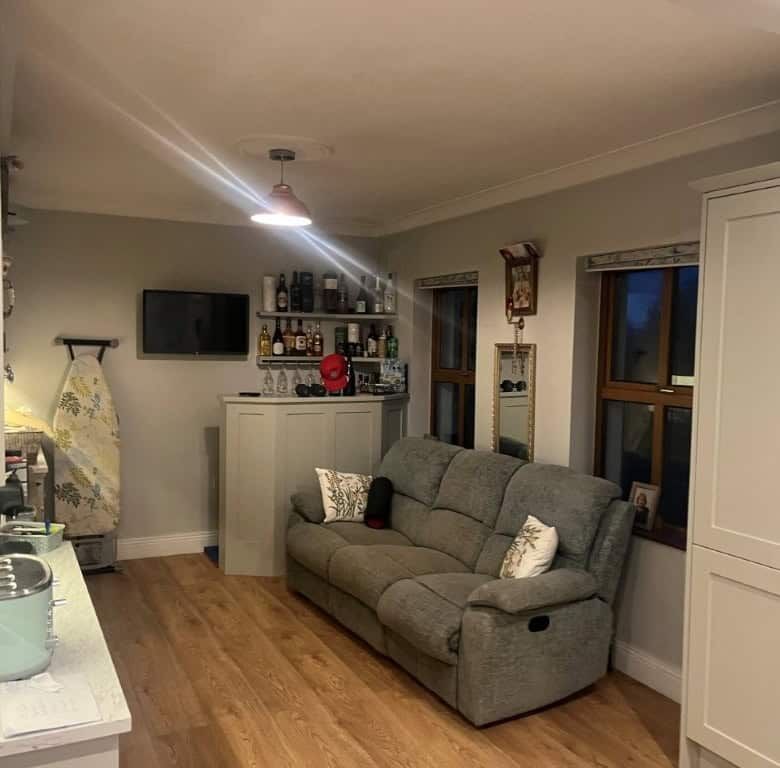 Spacious living room with comfortable sofa and modern decor in a beautiful Irish estate.