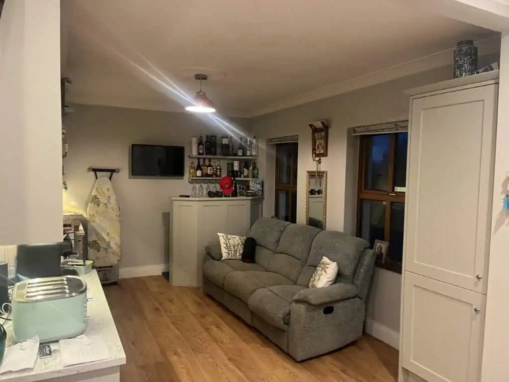 Spacious living room with comfortable sofa and modern decor in a beautiful Irish estate.