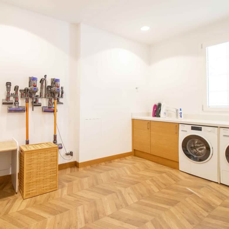 Spacious laundry area featuring a washing machine, cabinets, and natural light in Kyrenia North.