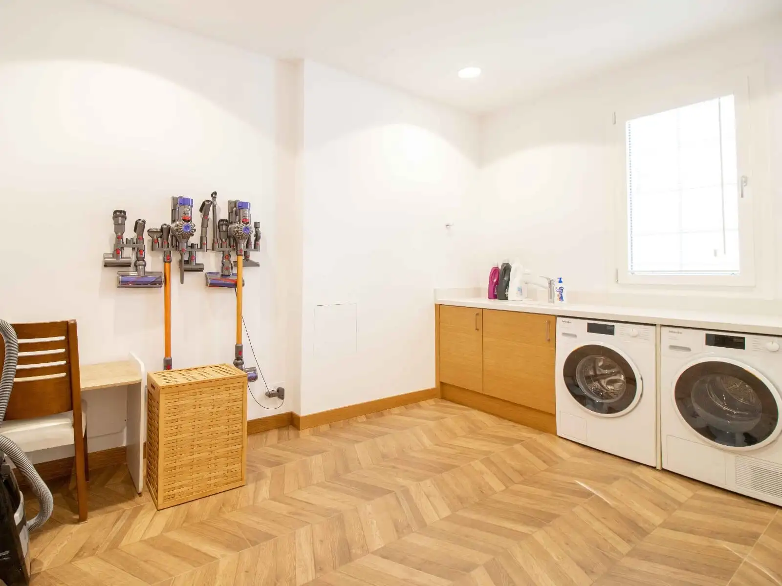 Spacious laundry area featuring a washing machine, cabinets, and natural light in Kyrenia North.