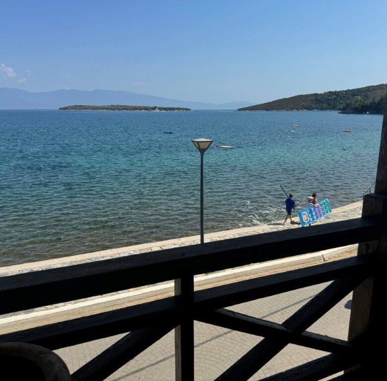 Beachfront view of Amaliapoli with clear blue waters and a scenic coastline.