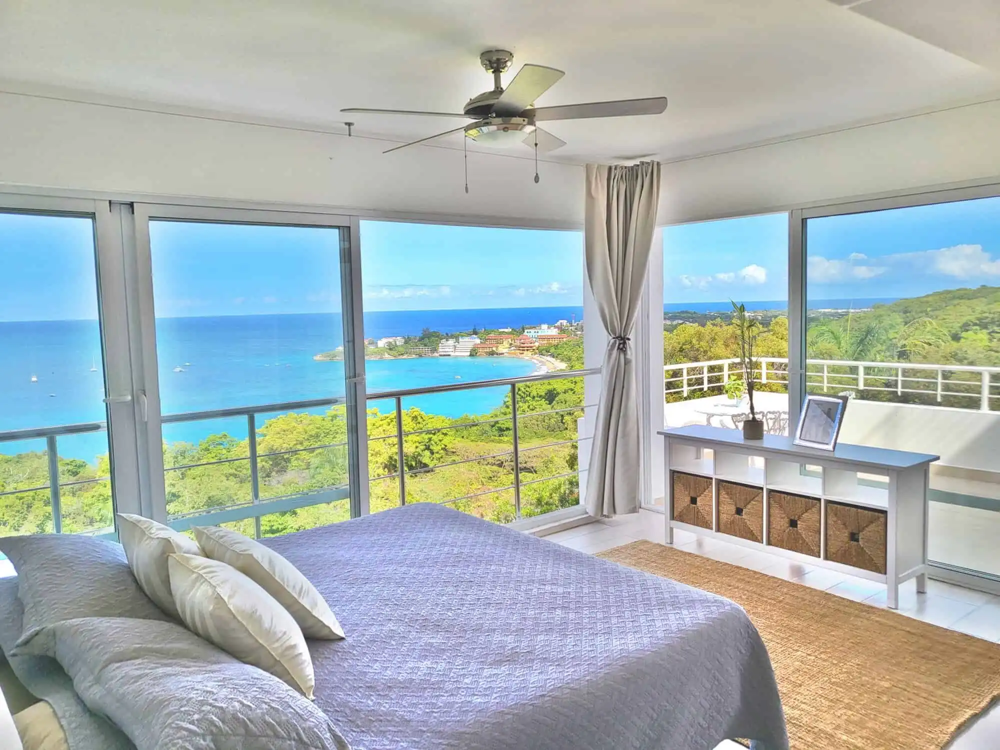 Ocean view bedroom with large windows overlooking the Caribbean Sea.