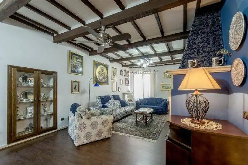 Cozy living room with traditional wooden beams and elegant decor in Panicale, Perugia, Umbria.