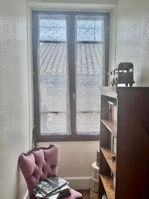 Balcony with decorative glass doors in a charming French home.