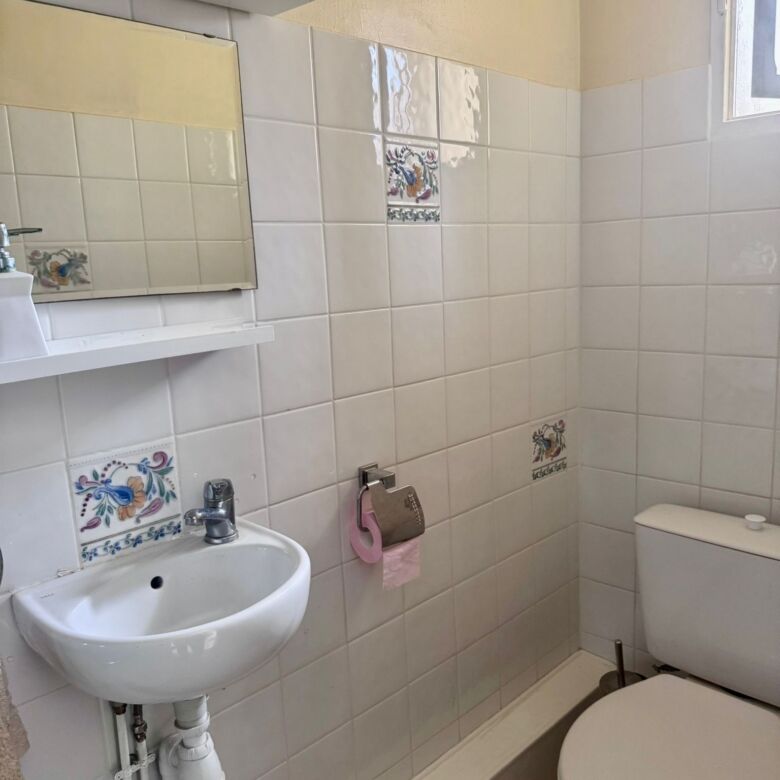 Charming bathroom with small sink and toilet in a modern townhouse. Perfect for comfortable living i.