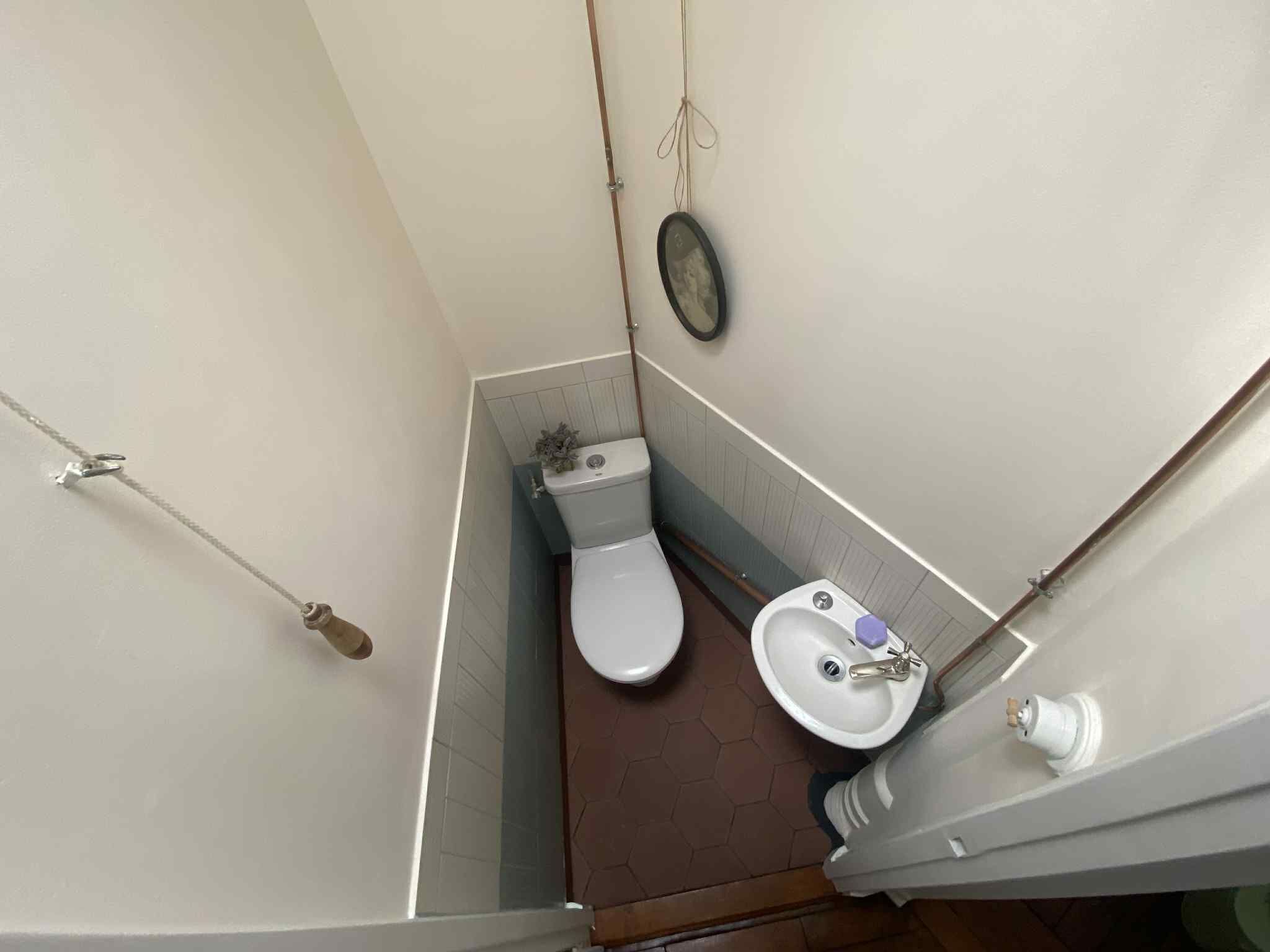 Cozy bathroom with toilet and sink in a Parisian apartment. Perfect for investment or living in the.
