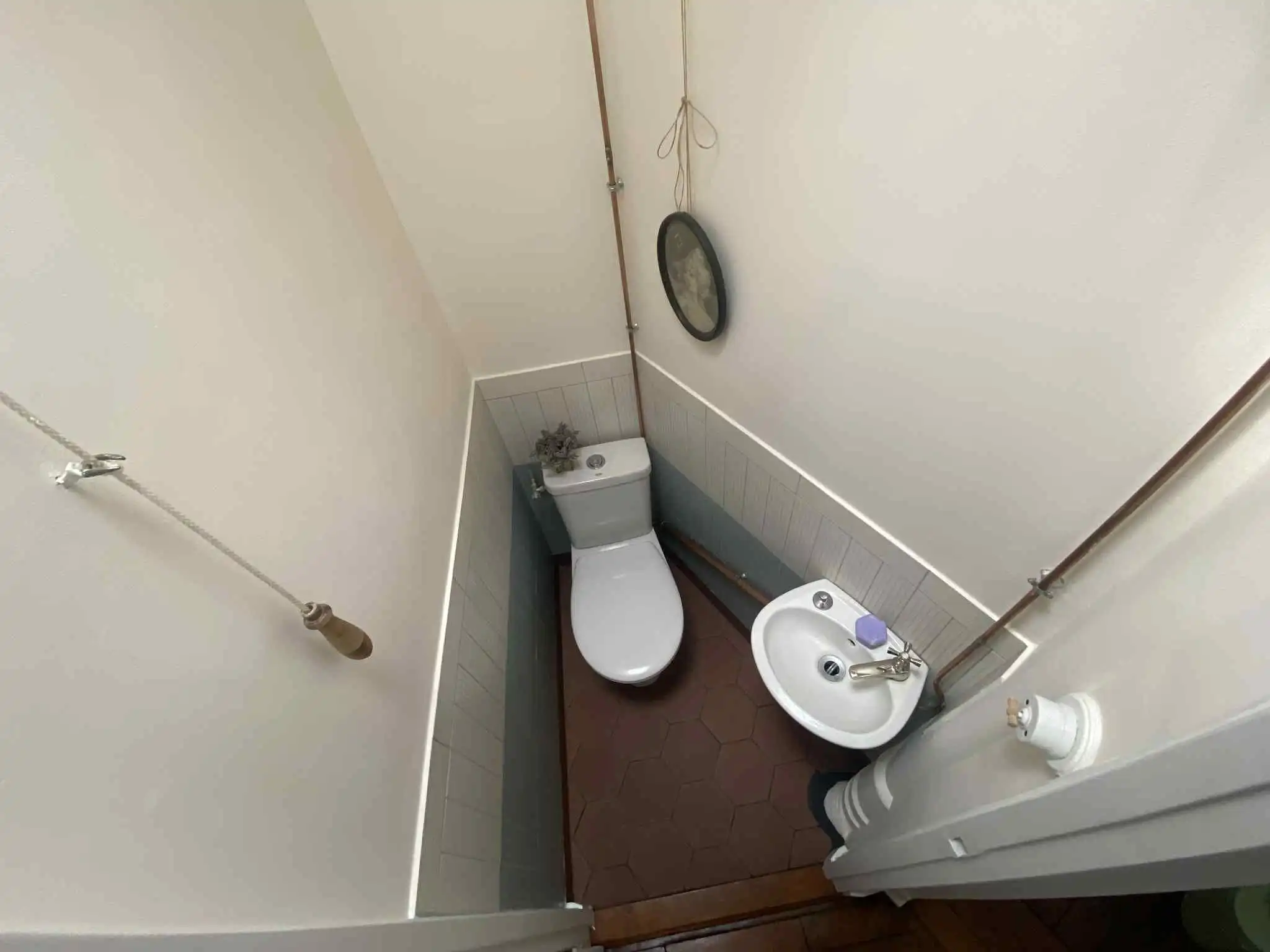 Cozy bathroom with toilet and sink in a Parisian apartment. Perfect for investment or living in the.