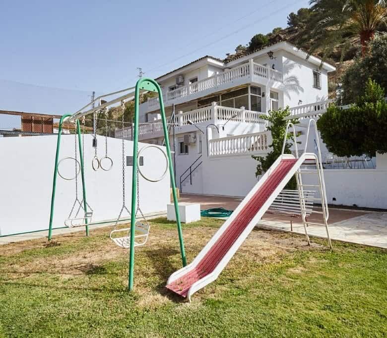 Spacious outdoor area with playground and slide at a luxury country estate in La Cerradura, Jaen.