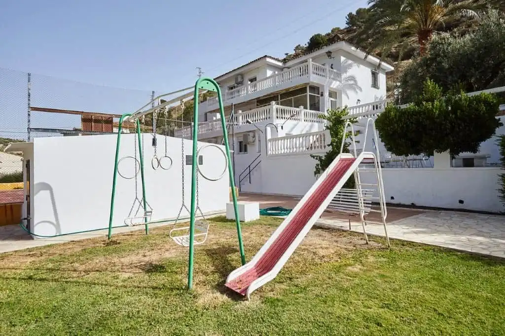 Spacious outdoor area with playground and slide at a luxury country estate in La Cerradura, Jaen.