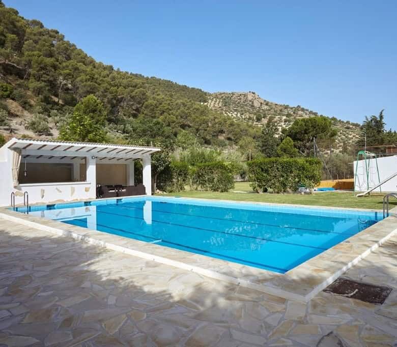 Beautiful outdoor pool at a 7-bedroom estate in La Cerradura, Jaen, surrounded by scenic hills.