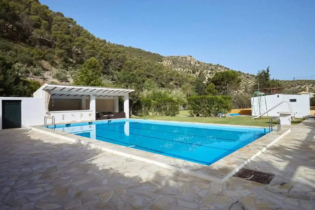 Beautiful outdoor pool at a 7-bedroom estate in La Cerradura, Jaen, surrounded by scenic hills.
