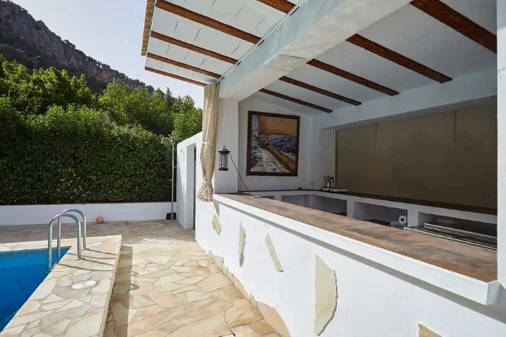 Beautiful outdoor area of a 7-bedroom estate in La Cerradura, Jaen, featuring a pool and scenic moun.