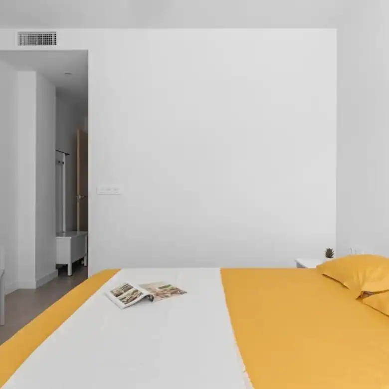 Apartment with bright living space and yellow bedding in Santiago De La Ribera Murcia.