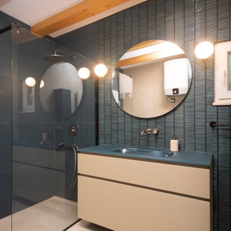 Contemporary bathroom featuring sleek design, round mirrors, and modern lighting in an exclusive Spl.
