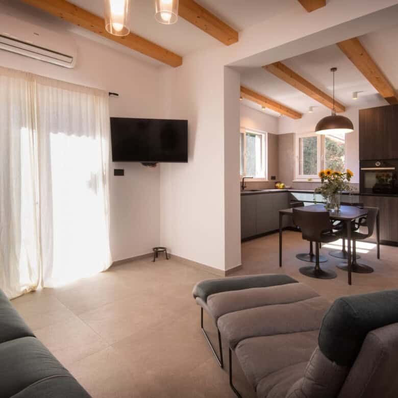 Cozy living room with large windows, neutral decor, and contemporary furnishings.
