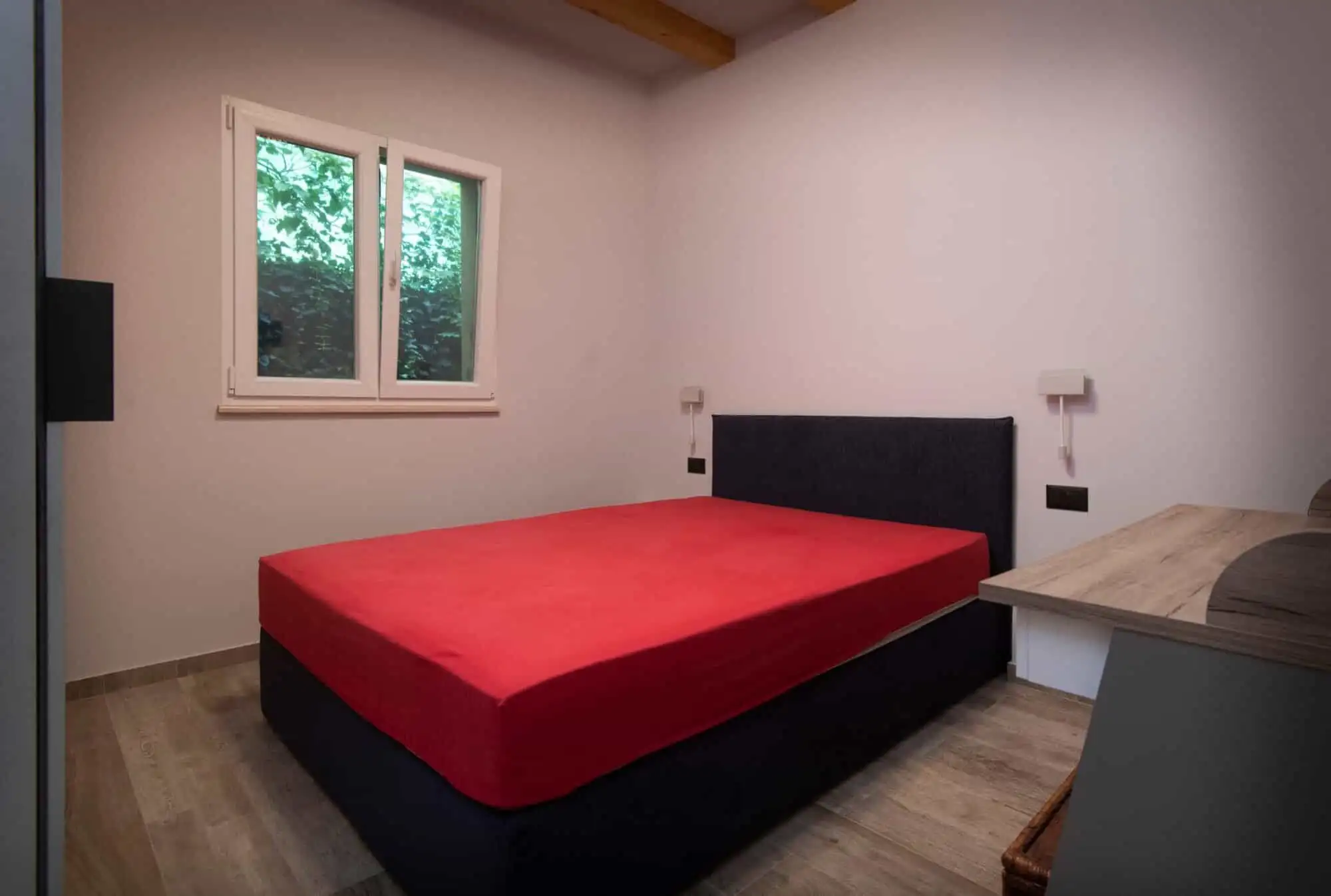 Modern bedroom with large window and minimalist decor. Modern bedroom with large window and minimalist decor.