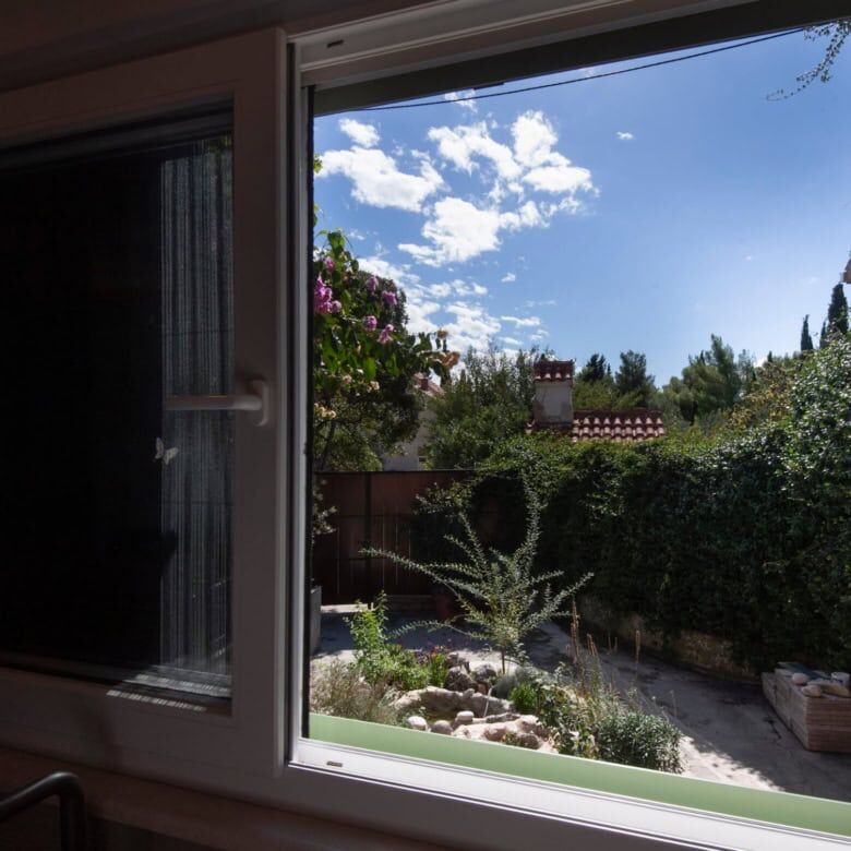 View of a garden from a single-storey house window in Split, Croatia.
