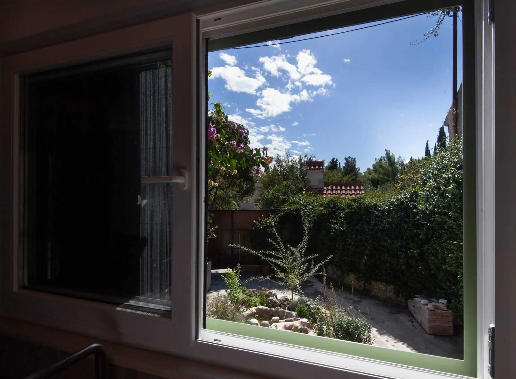 Storey House in Split View of a garden from a single-storey house window in Split, Croatia.