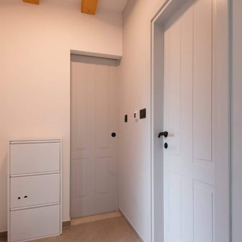 Bright hallway featuring white doors and minimalist decor in a high-end Split residence.