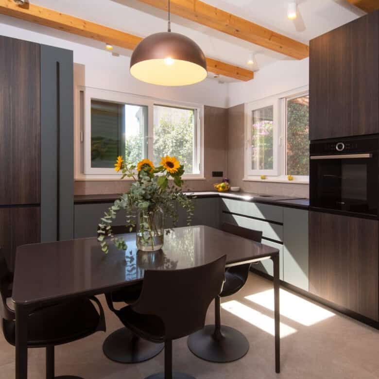 Elegant kitchen with dark cabinetry and bright natural light in Split.