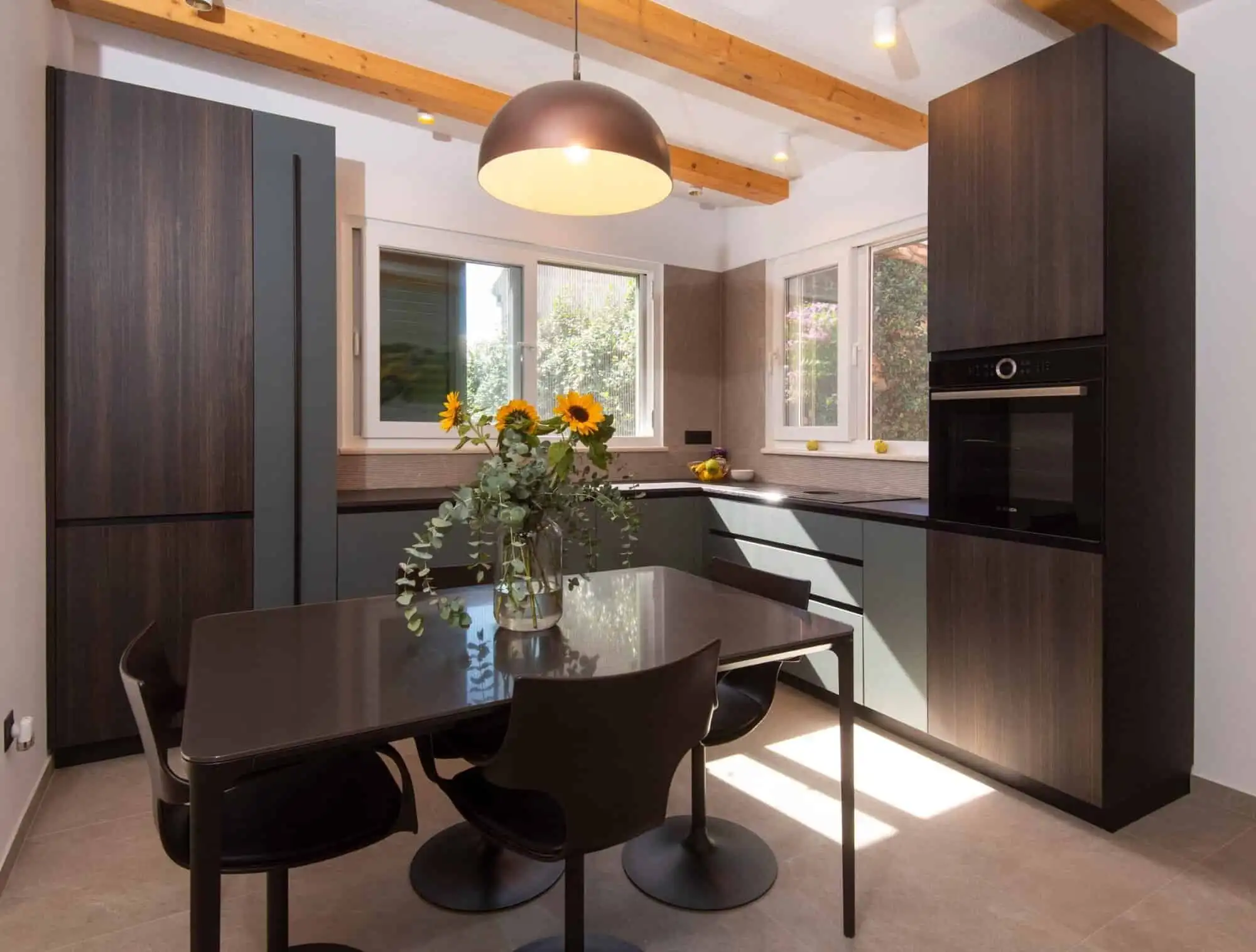 Modern kitchen in exclusive Split area with high single-storey design. Elegant kitchen with dark cabinetry and bright natural light in Split.