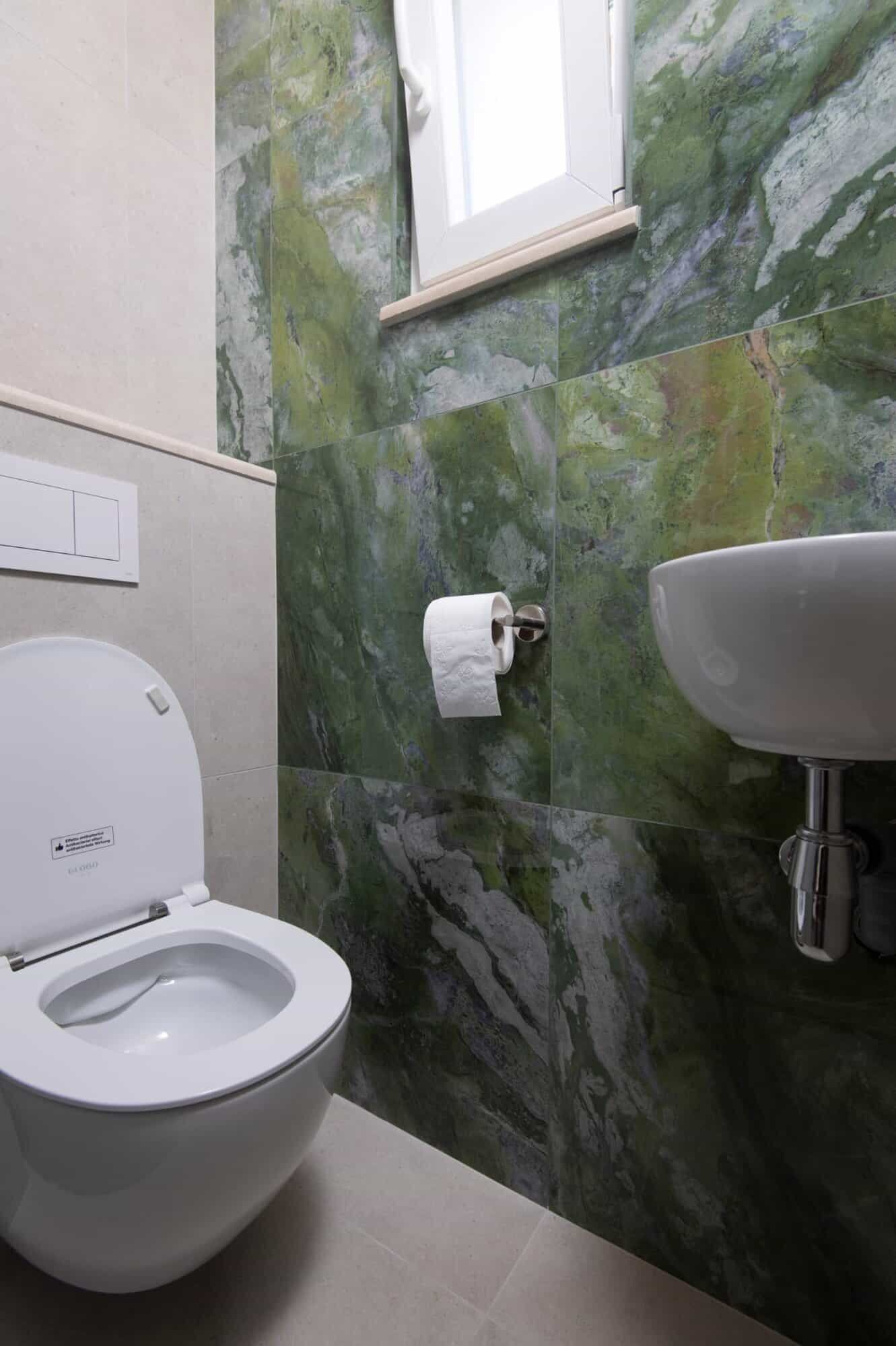storey house in exclusive area of Split Modern bathroom in a luxurious Split home with green marble walls and sleek fixtures.