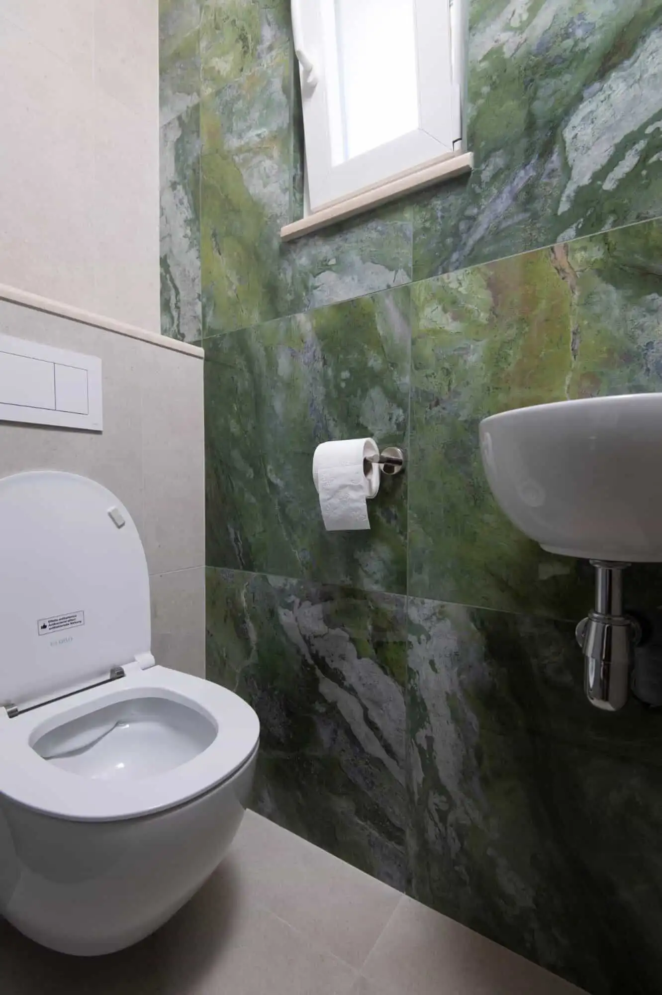 storey house in exclusive area of Split Modern bathroom in a luxurious Split home with green marble walls and sleek fixtures.
