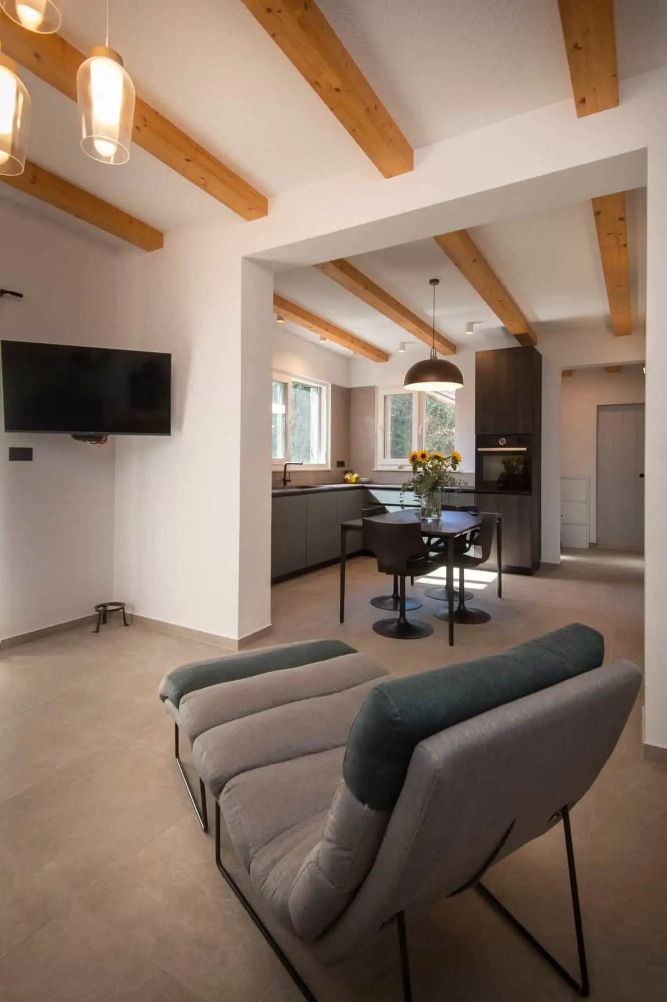 storey house interior in Split’s exclusive area. Plan living space with wooden ceiling beams and contemporary decor.