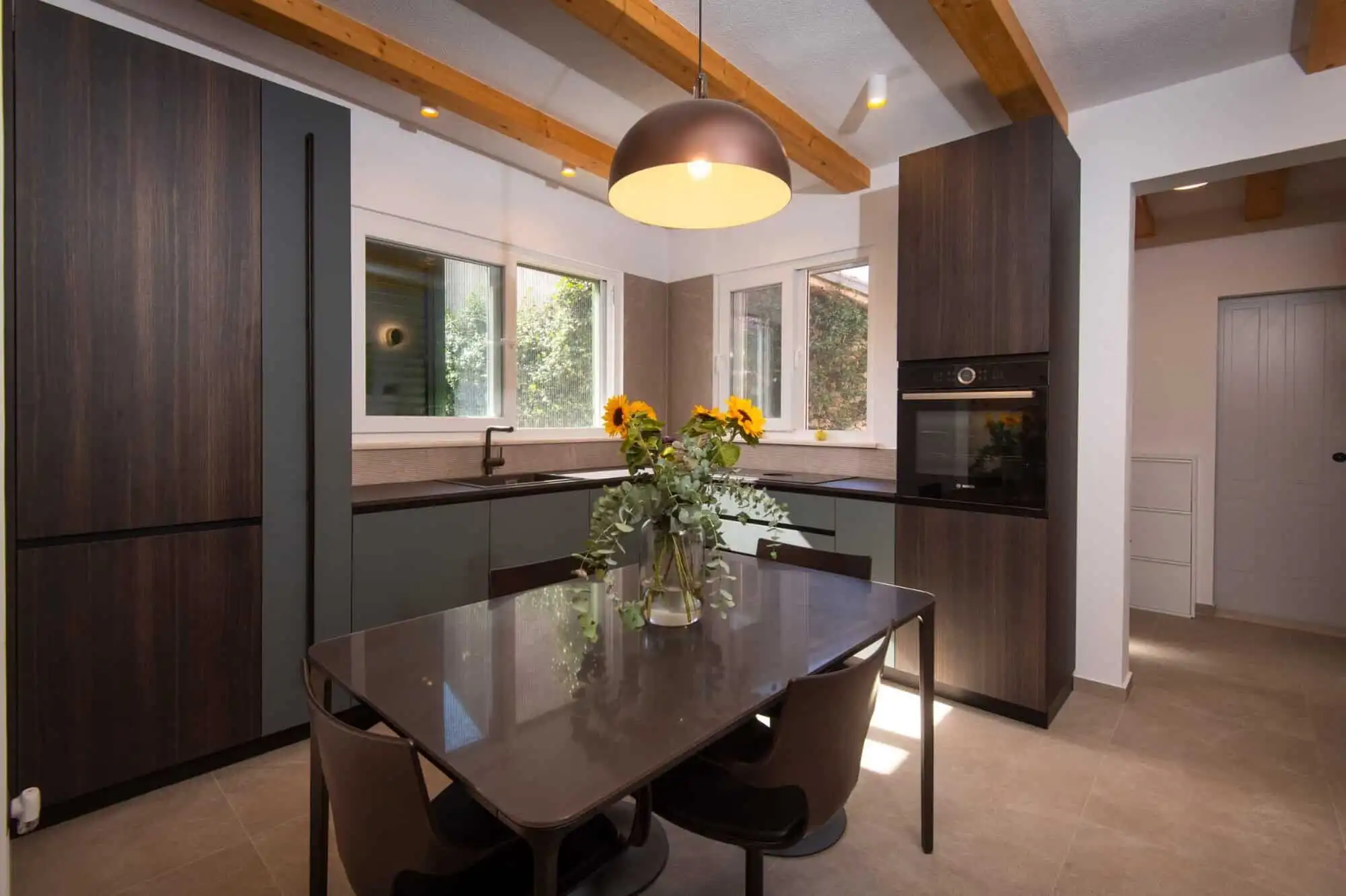 Modern kitchen in exclusive Split area Modern kitchen with dark cabinetry and large windows in Split.