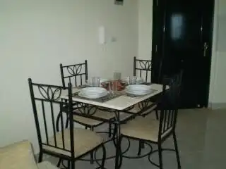 Apartment with dining table and four chairs in Oasis 5 complex, Hurghada.