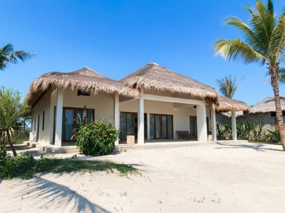 Luxury villa with thatched roof on Sumba's pristine beach. Perfect for investors seeking exclusive b.