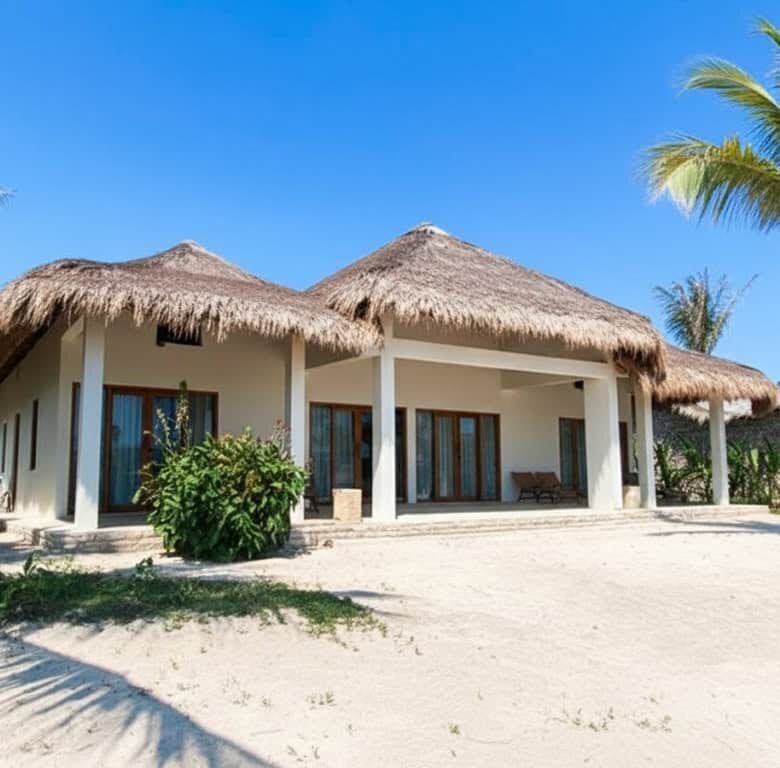 Luxury villa with thatched roof on Sumba's pristine beach. Perfect for investors seeking exclusive b.