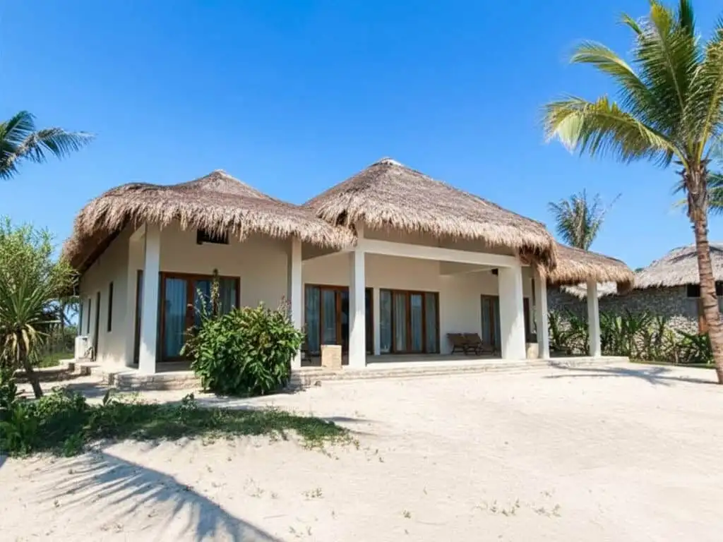 Luxury villa with thatched roof on Sumba's pristine beach. Perfect for investors seeking exclusive b.
