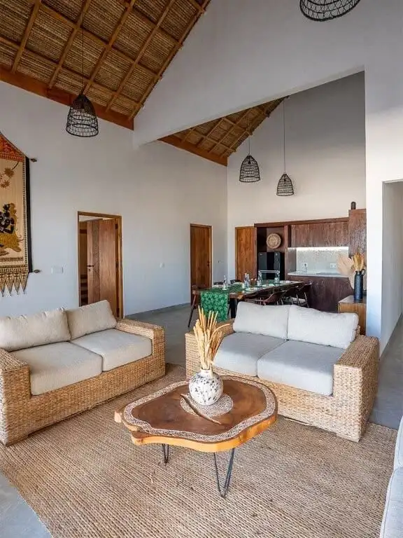 Beachfront villa interior with natural wood accents and cozy seating area.