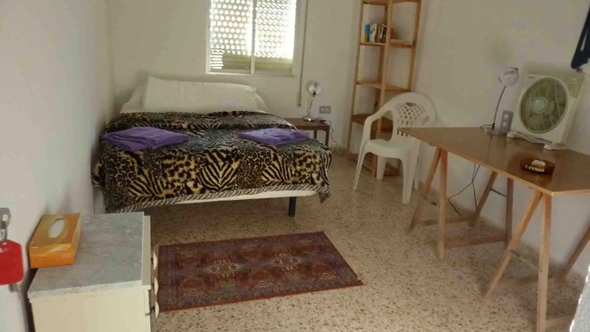 Bright bedroom featuring a large window and simple decor in Valencia property.