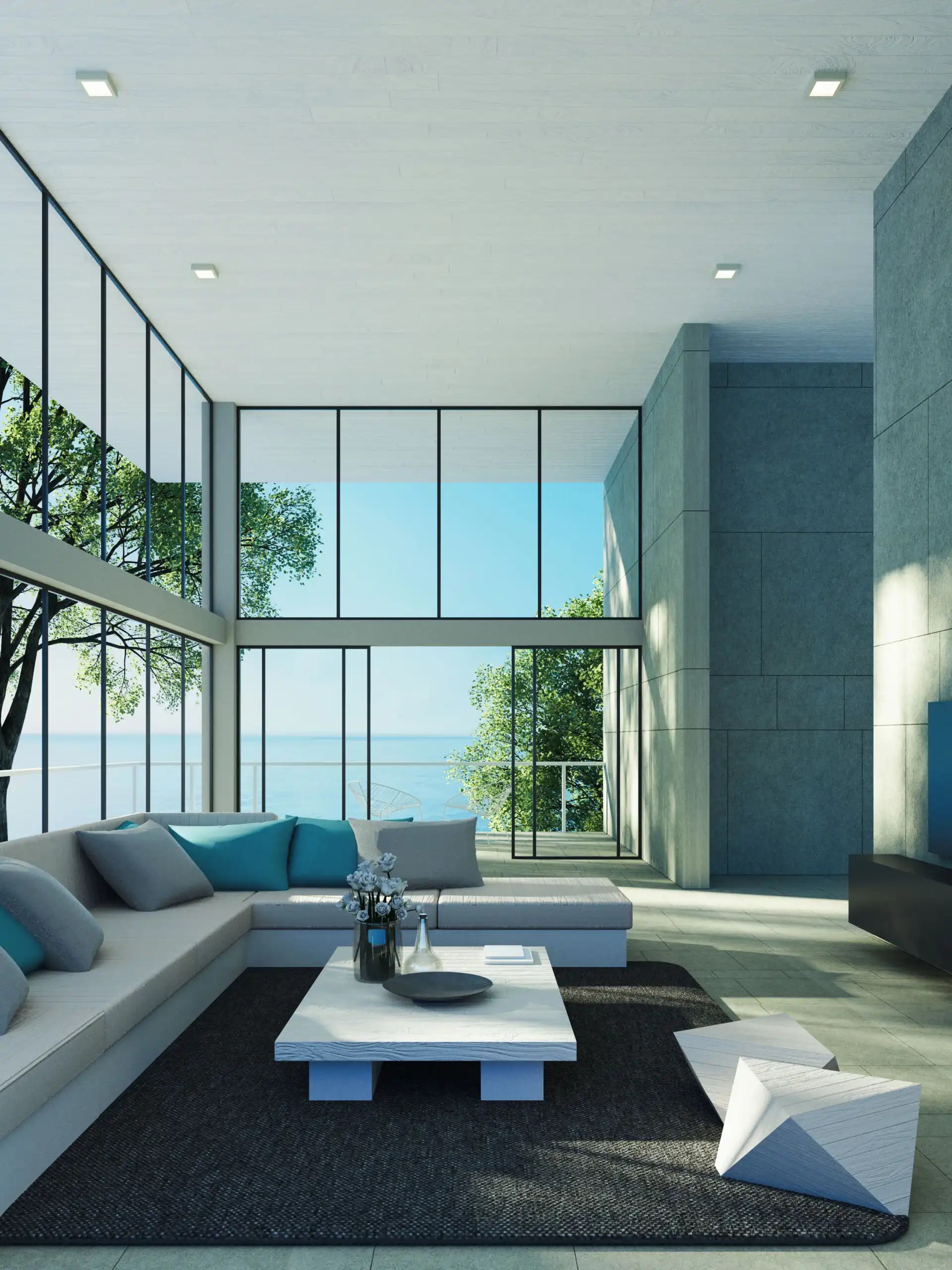 Modern living room with expansive glass windows overlooking the sea and lush greenery.