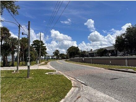 Plot of land for sale in Orlando, Florida with clear skies and residential surroundings.