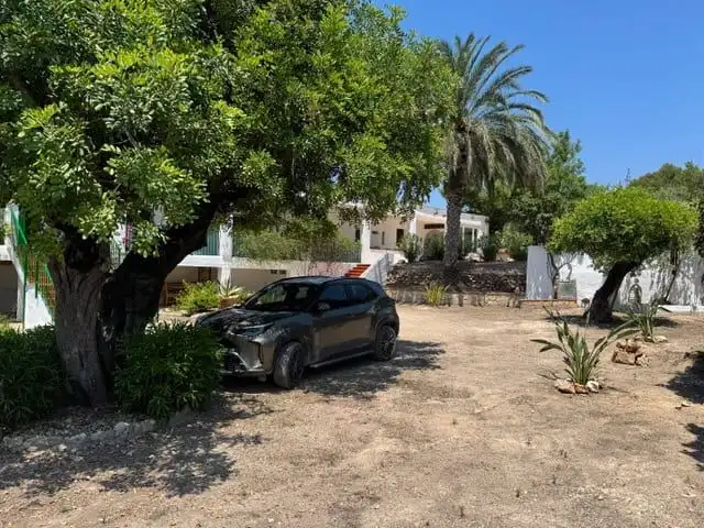 Spacious 3-bedroom villa in Guadassuar, Valencia, featuring lush garden, mature trees, and parking a.
