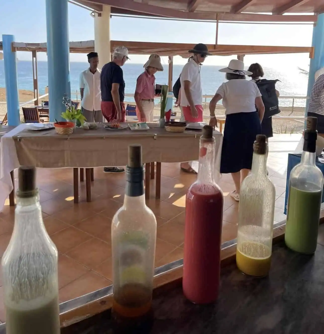 Beautiful seaside restaurant with guests enjoying a meal overlooking the ocean.