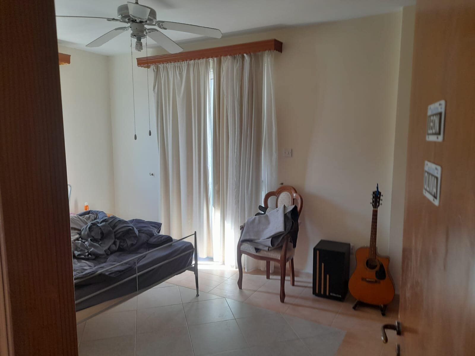 Spacious living room with large window and natural light in a 4-bedroom villa in Aradippou, Larnaca.